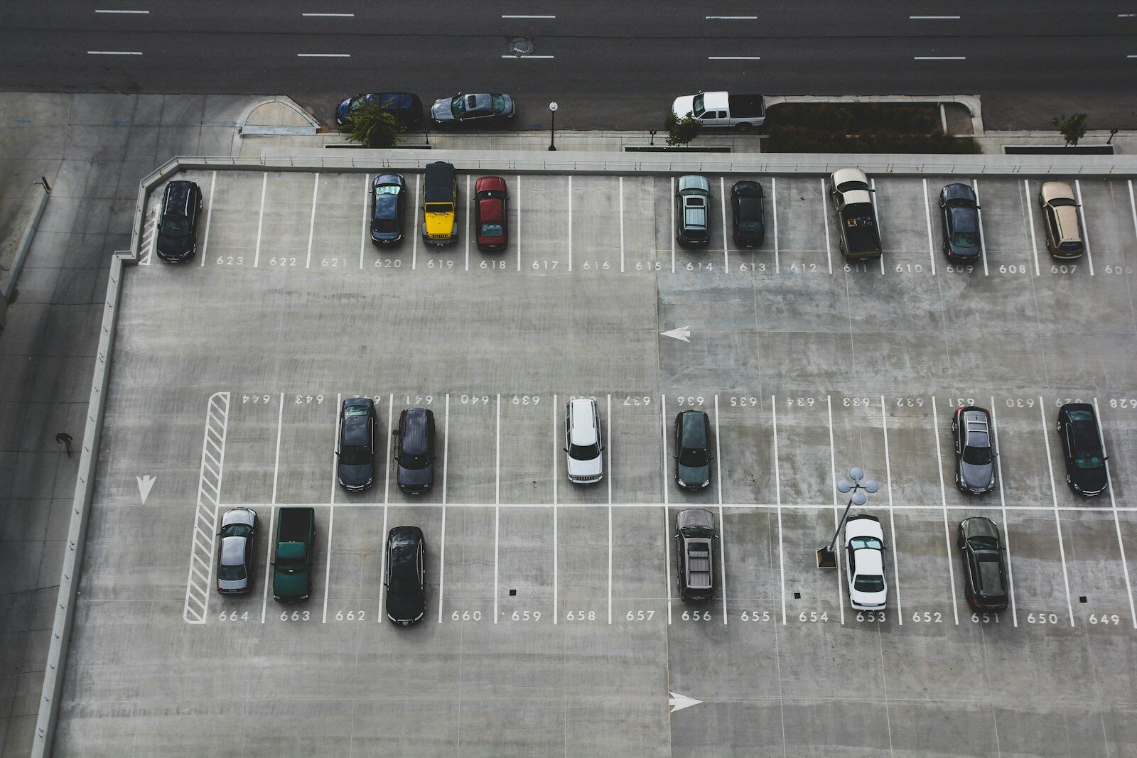 Aerial view of a parking lot filled with rows of fleet vehicles