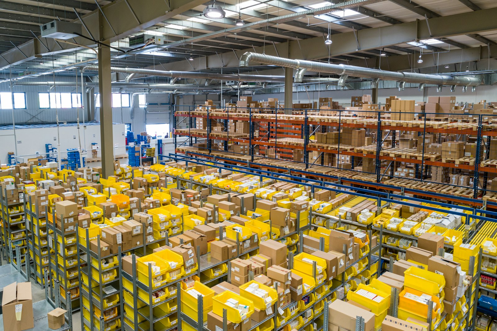 Rows of shelving stacked with packages inside a distribution warehouse